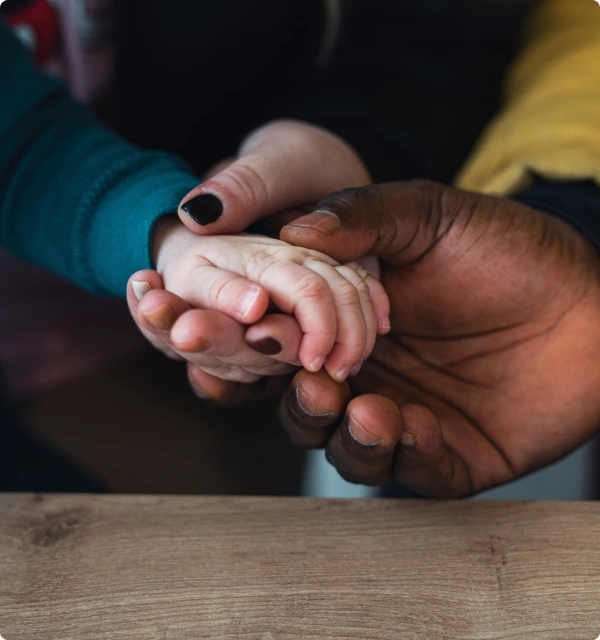 Manos de dos personas unidas sobre una mesa